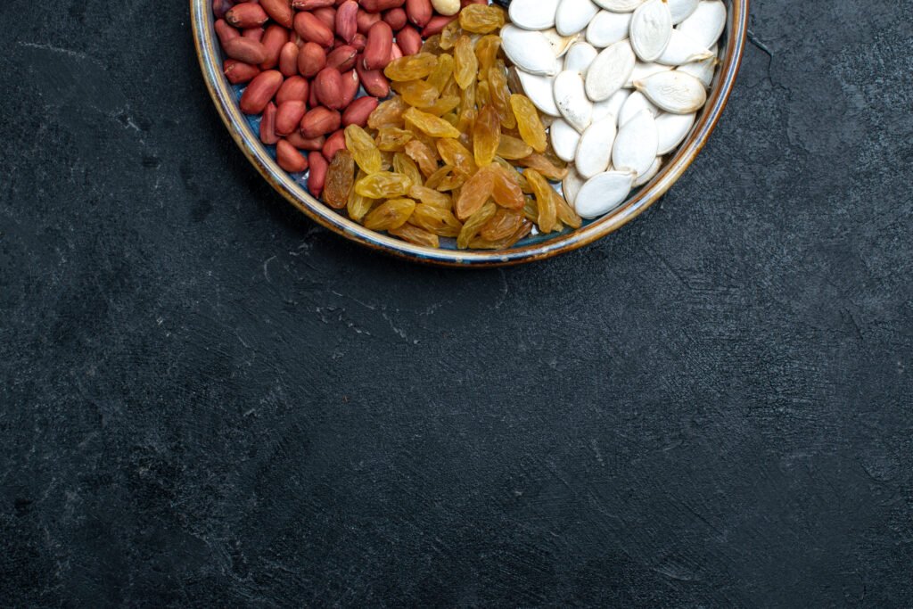 top view hazelnuts raisins other nuts dark grey background nuts snack dry fruit